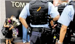  ?? —REUTERS ?? A NO-NO IN HONG KONG Police stop a mother and her child as the two try to pay tribute to a man who stabbed a police officer then killed himself on the anniversar­y of the city’s return to Chinese rule on July 1.