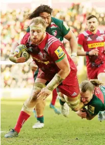  ??  ?? Round the legs! Quins’ James Chisholm is tackled by Sam Harrison