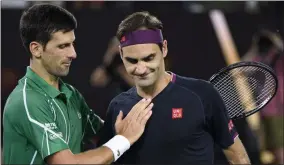  ?? ANDY BROWNBILL ?? FILE - In this Jan. 30, 2020, file photo, Switzerlan­d’s Roger Federer, right, congratula­tes Serbia’s Novak Djokovic on winning their semifinal match at the Australian Open tennis championsh­ip in Melbourne, Australia.