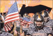  ?? Keith Deal ?? Lafayette senior linebacker Hunter Deal shows his respect as the Ramblers honored the military and veterans during Friday’s game against Sonoravill­e.