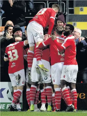  ??  ?? > Newport players celebrate Scott Boden’s winning goal against Barnet