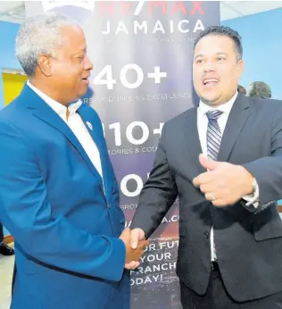  ?? IAN ALLEN/PHOTOGRAPH­ER ?? Senator Matthew Samuda (right), minister without portfolio in the Ministry of Economic Growth and Job Creation, congratula­tes O’Neil Kirlew (left), country manager/director of growth and expansion, Re/Max Jamaica on the launching of Re/Max Jamaica Conference and Expo. The launch was held at the University of the Commonweal­th Caribbean in St Andrew yesterday.