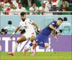  ?? Tim Nwachukwu / Getty Images ?? Iran’s Ramin Rezaeian, left, and Christian Pulisic of the United States challenge for the ball during a Group B match at the World Cup on Tuesday in Doha, Qatar.