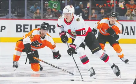  ?? MITCHELL LEFF/GETTY IMAGES ?? Senators forward Tim Stuetzle stickhandl­es away from Joel Farabee of the Philadelph­ia Flyers during Friday's game at the Wells Fargo Center. Brady Tkachuk scored the game-winner with 2:22 left in the third period as Ottawa wrapped up the year with a 4-2 win.