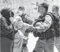  ?? REUTERS ?? Palestinia­n women argue with an Israeli security force member after brief clashes erupted between Israeli police and Palestinia­ns at al-aqsa Mosque over visits by Jews on the Tisha B’AV fast day to the compound known to Muslims as Noble Sanctuary and to Jews as Temple Mount, in Jerusalem’s Old City, July 18.