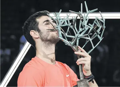  ?? Picture: AFP ?? MASSIVE SCALP. Russia’s Karen Khachanov kisses the trophy after surprising Novak Djokovic in the final of the Paris Masters on Sunday.