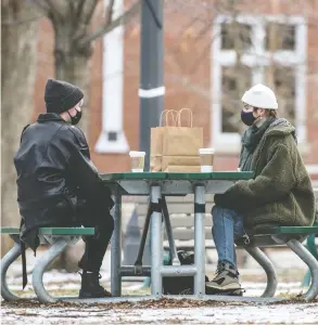  ?? PETER J THOMPSON / FINANCIAL POST ?? Two people chat in Toronto's Trinity Bellwoods Park this week. Despite looming COVID-19 restrictio­ns, economists have upgraded their forecasts for next year based on a
boost to consumer confidence thanks to 400,000 early vaccine doses.