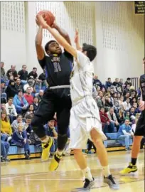  ?? SAM STEWART - DIGITAL FIRST MEDIA ?? Downingtow­nWest’s Wayne Anderson goes up for a shot during the first half while guarded by Spring-Ford’s Nestor Diaz.