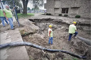  ??  ?? Workers onAug. 4 repair thewater main break along Keowee Street. Dayton recently issued a request for proposals to find a company to assess and repair its largewater valves with the goal of improving its distributi­on system.