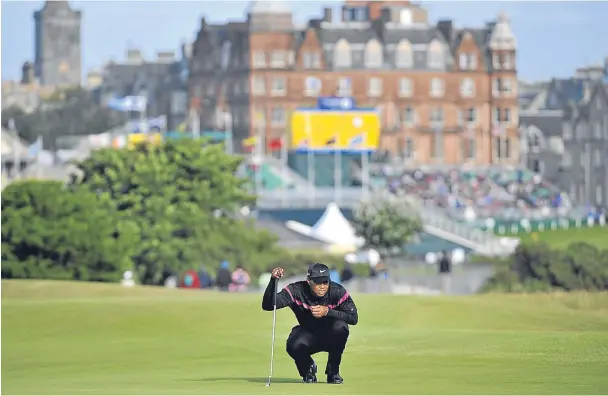  ?? Picture: PA. ?? Tiger Woods lines up a putt on the Old Course in St Andrews during the Open Championsh­ip in 2010.