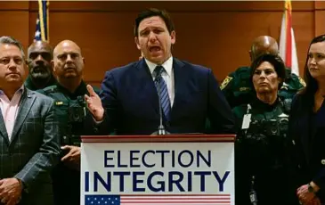  ?? AMY BETH BENNETT/SOUTH FLORIDA SUN SENTINEL VIA AP ?? Florida Governor Ron DeSantis announced criminal charges in August against 20 people for illegally voting in 2020, the first major move by his election police unit.