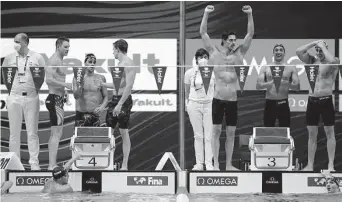  ?? Petr David Josek/Associated Press ?? Italy’s men’s team, right, celebrates winning the 4x100 medley relay over the second-place United States team at the 19th FINA World Championsh­ips in Budapest, Hungary.