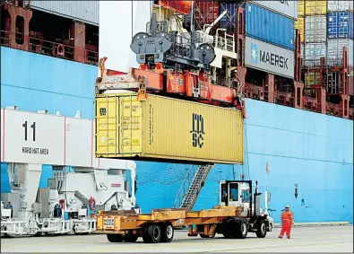  ?? AP/PATRICK SEMANSKY ?? A shipping container is loaded onto a waiting trailer at the Port of Baltimore in this file photo. The trade deficit, the gap between U.S. imports and exports of goods and services, fell to $46.5 billion in May, the Commerce Department said Thursday.