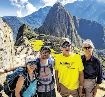  ?? Photo courtesy of Robert Harrington and Bella Media ?? Michael McCulloch, second from right, a retired NASA engineer who is blind, was able to complete a hike of Machu Picchu with the help of three guides.