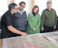  ?? JEFF MCINTOSH THE CANADIAN PRESS FILE PHOTO ?? Nenshi, fire chief Bruce Burrell, left, Alberta premier Alison Redford and prime minister Stephen Harper examine a map of the flooded areas of Calgary in June 2013. The flood was one of the first major crises that Nenshi would deal with as mayor.