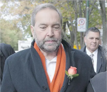  ?? RYAN REMIORZ/ THE CANADIAN PRESS ?? NDP Leader Tom Mulcair leaves after visiting with campaign volunteers Monday in Montreal.