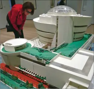  ?? AP PHOTO ?? A visitor reviews a model of the Solomon R. Guggenheim Museum during the press preview for the MOMA exhibition “Frank Lloyd Wright at 150: Unpacking the Archive.”