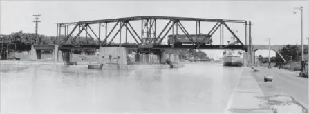  ?? R. J. SANDUSKY SPECIAL TO THE ST. CATHARINES STANDARD ?? Looking north towards the Thorold swing bridge No. 8 Main Line N.S.&amp;T. is closed with a rail car crossing it.