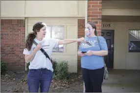  ?? (NWA Democrat-Gazette/Charlie Kaijo) ?? Kelly Krout (left) and friend Sofie Dill drop off info cards as she campaigns Friday at The Links apartment complex in Lowell. Krout is running in the House district 90 race in Rogers and Lowell.