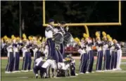 ?? JONATHAN TRESSLER — THE NEWS-HERALD ?? Members of the Wickliffe High School Marching Band, also known as the Blue Devil Swing Band, perform their trademark pyramid maneuver during the ensemble’s longstandi­ng performanc­e of Age of Aquarius during the 2018 LCMEA Marching Band Festival Sept. 26.