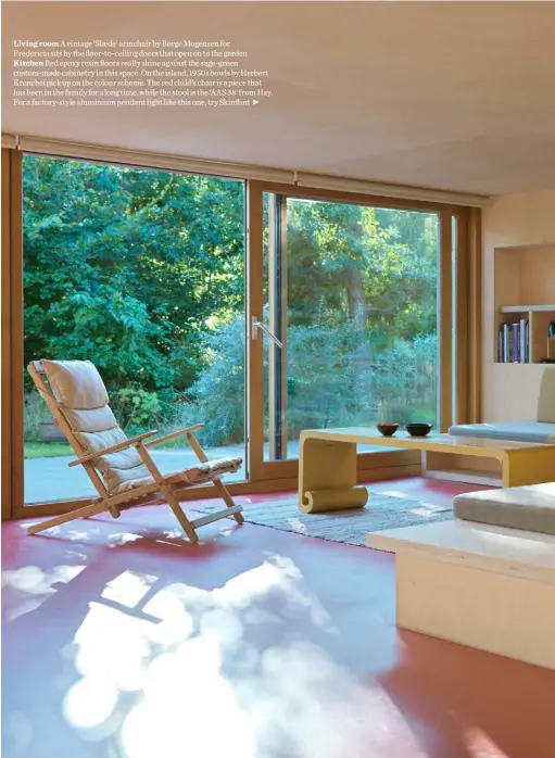  ??  ?? Living room A vintage ‘Slæde’ armchair by Børge Mogensen for
Fredericia sits by the floor-to-ceiling doors that open on to the garden Kitchen Red epoxy resin floors really shine against the sage-green custom-made cabinetry in this space. On the island, 1950s bowls by Herbert Krenchel pick up on the colour scheme. The red child’s chair is a piece that has been in the family for a long time, while the stool is the ‘AAS 38’ from Hay. For a factory-style aluminium pendant light like this one, try Skinflint