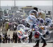  ?? Myung J. Chun Los Angeles Times ?? CROWDS will again return to the Santa Monica Pier if plans to reopen the state June 15 come to fruition.