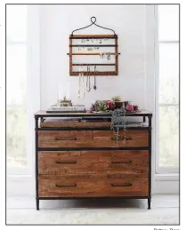  ?? Pottery Barn ?? Show off your earrings and necklaces, even when you’re not wearing them, with a space-saving, wall-mounted hanger, such as Pottery Barn’s pine and iron wall-mounted jewelry hanger, $99.