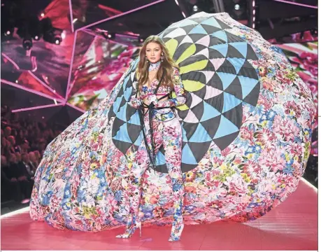  ??  ?? Floral flourish: Hadid walking the runway during the fashion show at Pier 94, New York. — AP