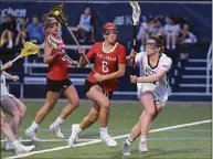  ?? Dave Stewart / Hearst Connecticu­t Media ?? New Canaan’s Kaleigh Harden (6) drives to the net while Wilton’s Whitney Hess defends on April 13.