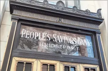  ??  ?? A vintage sign remains on the original People’s Savings Bank building in downtown Bridgeport.