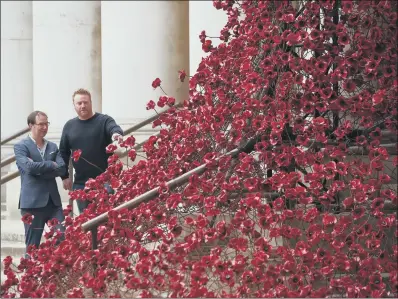  ?? PICTURE: PA WIRE ?? TRIBUTE: Designer Tom Piper, left, and artist Paul Cummins with their poppy sculpture Weeping Window at the Imperial War Museum.