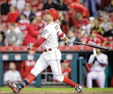  ?? ANDY LYONS / GETTY IMAGES ?? The Reds’ Joey Votto hits a seventh-inning home run, breaking a scoreless tie and tying him with Jason Bay for fourth place in homers by a native of Canada. He has 222 career home runs.