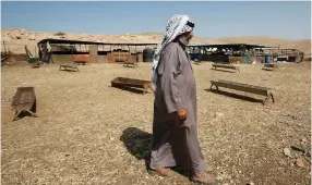  ??  ?? A BEDUIN man walks in the Jordan Valley.