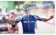  ??  ?? Quick-Step Floors Team's French cyclist Julian Alaphilipp­e celebrates as he crosses the finish line to win the 8th stage of the 72nd edition of ‘La Vuelta’ Tour of Spain cycling race on Saturday. (AFP)