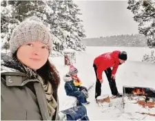  ?? Veera Lavikkala / Washington Post ?? Veera Lavikkala, a consultant at a software company located near Helsinki, cooks hot dogs in the snow with her family.