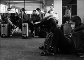  ?? AP Photo/Jef Chiu ?? Passenger Cari Driggs (right) from Provo, Utah, waits to board a United Airlines flight to Hawaii for vacation at San Francisco Internatio­nal Airport in San Francisco, on Thursday.