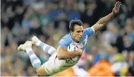  ?? Picture: REUTERS ?? FLYING PUMA: Argentina’s Juan Imhoff goes over for his side’s fourth try against Ireland yesterday.