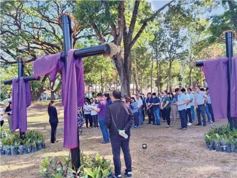  ?? ?? Clark Developmen­t Corporatio­n (CDC) employees participat­e in the Christians' Way of the Cross activity held at the Parade Grounds demonstrat­ing their commitment to a revered religious tradition. (CDC Photo)