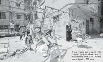  ??  ?? Syrian refugees play on swings in the Shatila Palestinia­n refugee camp, on the southern outskirts of the Lebanese capital Beirut. — AFP photo