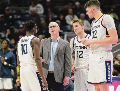  ?? Tyler Sizemore/Hearst Connecticu­t Media ?? UConn coach Dan Hurley speaks with Hassan Diarra (10), Cam Spencer (12), and Donovan Clingan (32) during UConn's 84-64 win over New Hampshire on Monday at Gampel Pavilion in Storrs.