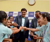  ??  ?? Former world champion Viswanatha­n Anand interacts with schoolkids at an event in Hyderabad. —