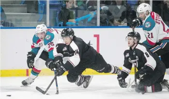  ?? CHRIS RELKE ?? James Malm of the Vancouver Giants lunges for a loose puck in front of Cal Foote of the Kelowna Rockets during Friday’s Western Hockey League game at the Langley Events Centre, won by Kelowna 6-4.