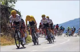  ?? PETER DEJONG — THE ASSOCIATED PRESS ?? Britain’s Chris Froome, wearing the overall leader’s yellow jersey, speeds downhill with his Sly teammates as they lead the pack during the 16th stage of the Tour de France cycling race Tuesday.