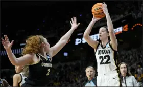  ?? MARY ALTAFFER — THE ASSOCIATED PRESS ?? Iowa guard Caitlin Clark, right, shoots against Colorado guard Frida Formann during the second quarter of their NCAA Tournament Sweet 16 game Saturday in Albany, N.Y.