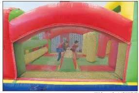  ?? NWA Democrat-Gazette/J.T. WAMPLER ?? Children race through an inflatable obstacle course Monday at The Jones Center in Springdale.