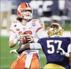  ?? Jared C. Tilton / TNS ?? Clemson quarterbac­k Trevor Lawrence looks to pass in the fourth quarter against Notre Dame during the ACC Championsh­ip game at Bank of America Stadium in Charlotte, N.C. on Saturday.