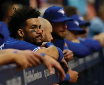  ?? BRIAN BLANCO/GETTY IMAGES ?? Devon Travis and teammates look on from the Jays dugout in the ninth inning of Sunday’s loss to the Rays.