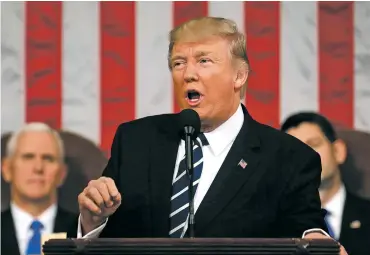  ?? JIM LO SCALZO/POOL IMAGE VIA AP ?? President Donald Trump addresses a joint session of Congress on Tuesday on Capitol Hill in Washington. Vice President Mike Pence, left, and House Speaker Paul Ryan of Wisconsin listen behind him.