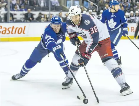  ?? ERNEST DOROSZUK/TORONTO SUN ?? Toronto’s Morgan Rielly defends against Columbus’s Boone Jenner during a 3-2 Maple Leafs loss on Monday in Toronto.