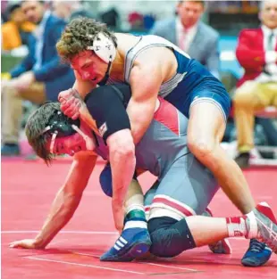  ?? CONTRIBUTE­D PHOTO BY PAUL STAUDER ?? McCallie’s Thomas Sell, top, wrestles Baylor’s Connor Duffy in their 182-pound state championsh­ip match Saturday night in Franklin. Sell won the match 7-6.